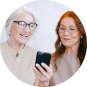 2 elderly ladies looking at a mobile phone